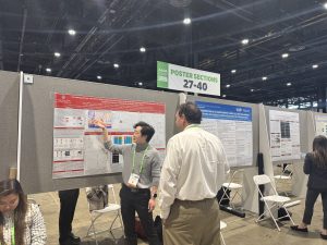 Alex Chang gives a poster presentation to an AACR attendee